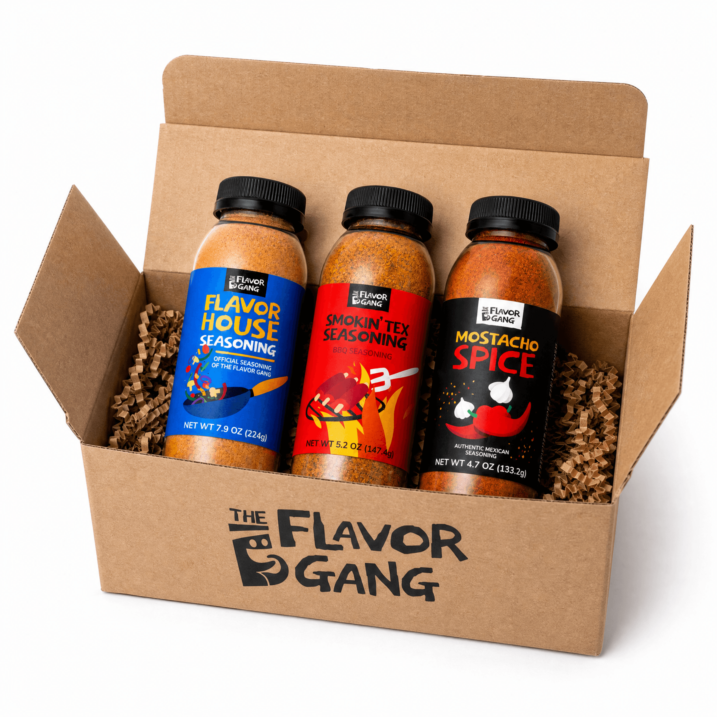 The Flavor Gang seasoning gift box with Flavor House, Smokin' Tex, and Mostacho Spice bottles in kraft packaging
