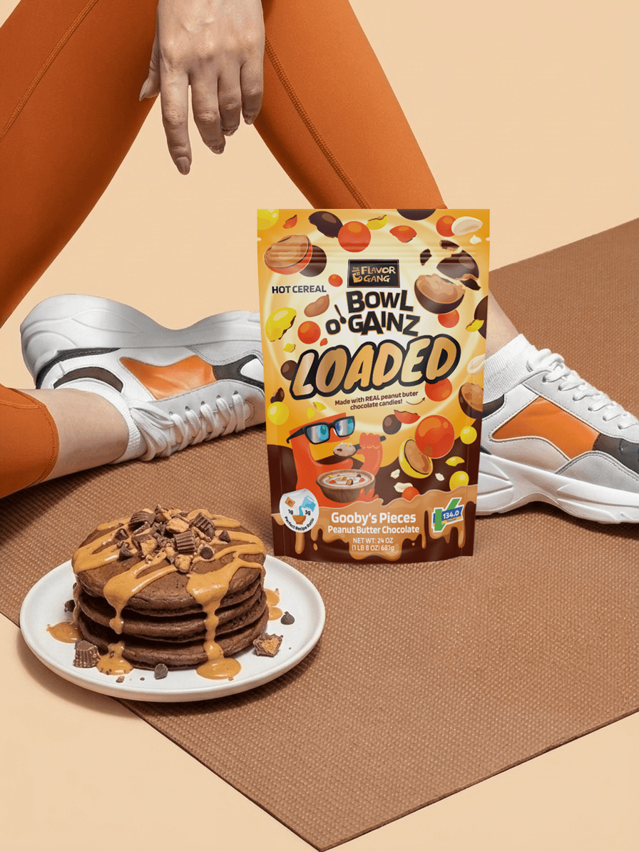 Bowl O' Gainz Loaded Gooby's Pieces peanut butter chocolate hot cereal pouch beside protein pancakes and gym sneakers